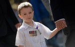 A young boy participates in the Anzac Day march through Sydney on April 25, 2013. Tens of thousands of Australians and New Zealanders turned out on April 25 to honour their war dead, with moving tributes to fallen mates and calls not to forget those injured in conflict.