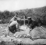 Three soldiers in a cemetery on the Gallipoli Peninsula tend the grave of 835 Private Patrick Michael McDonough, 7th Battalion, who was killed in action on 5 July 1915. Reprinted courtesy of the Australian War Memorial.